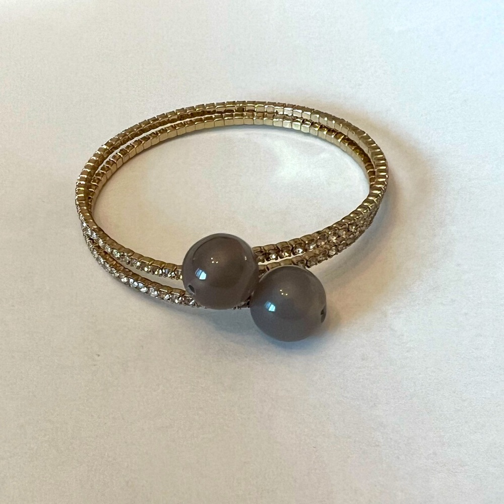 Gold plated wrap around bracelet with gray glass beads and crystals